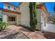Side view of a stucco home with a brick walkway and mature landscaping at 11444 Steponia Bay St, Las Vegas, NV 89141