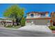 Charming two-story home with stucco exterior, well-manicured lawn, and a two car garage at 11444 Steponia Bay St, Las Vegas, NV 89141