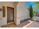 Front door with sidelight, covered porch, and desert landscaping at 11444 Steponia Bay St, Las Vegas, NV 89141
