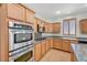 Kitchen showcasing wood cabinets, granite countertops, stainless steel appliances, and ample counter space at 11444 Steponia Bay St, Las Vegas, NV 89141
