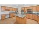 Bright kitchen featuring wood cabinets, granite countertops, and a center island at 11444 Steponia Bay St, Las Vegas, NV 89141