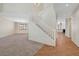 Spacious living room with plush carpeting, white staircase and an open layout at 11444 Steponia Bay St, Las Vegas, NV 89141