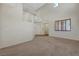 Spacious living room with plush carpeting, lots of natural light and an open layout at 11444 Steponia Bay St, Las Vegas, NV 89141
