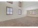 Open-concept living area featuring plantation shutters, neutral colors, and carpet at 11444 Steponia Bay St, Las Vegas, NV 89141