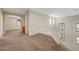 Upstairs loft area with soft carpet, neutral paint, and railing overlooking stairs at 11444 Steponia Bay St, Las Vegas, NV 89141