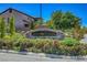 Beautiful San Niccolo community sign surrounded by colorful landscaping and lush green trees at 11444 Steponia Bay St, Las Vegas, NV 89141