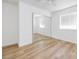 Bright bedroom featuring wood-look floors, a ceiling fan, and mirrored closet doors at 1300 Pinto Rock Ln # 201, Las Vegas, NV 89128