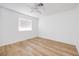 Bright bedroom featuring a clean aesthetic with wood laminate flooring and a large window at 1300 Pinto Rock Ln # 201, Las Vegas, NV 89128
