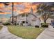 Inviting two-story condo with well-maintained landscaping and warm exterior lighting at sunset at 1300 Pinto Rock Ln # 201, Las Vegas, NV 89128