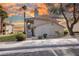 Two story condo building with pink doors in a landscaped setting at 1300 Pinto Rock Ln # 201, Las Vegas, NV 89128