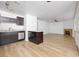 Modern kitchen with dark cabinets, stainless steel appliances, and a seamless flow into the spacious living area at 1300 Pinto Rock Ln # 201, Las Vegas, NV 89128