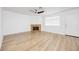 Spacious living room with modern lighting, a fireplace, laminate floors, and a bright front door entrance at 1300 Pinto Rock Ln # 201, Las Vegas, NV 89128
