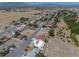 Aerial view of home featuring solar panels, desert landscaping, private driveway, and a quiet neighborhood at 1320 Daytona St, Pahrump, NV 89048