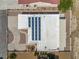 Drone overhead view of home's solar panels, desert landscaping, private driveway, and large roof at 1320 Daytona St, Pahrump, NV 89048