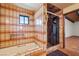 Bathroom featuring an alcove tub, glass shower, and tiled walls, plus a window for natural light at 1320 Daytona St, Pahrump, NV 89048