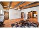 Open-concept living room with wood-beamed ceiling and Saltillo tile floors at 1320 Daytona St, Pahrump, NV 89048