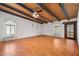 Spacious living room featuring exposed beam ceiling, tile flooring, and abundant natural light from multiple windows at 1320 Daytona St, Pahrump, NV 89048