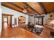 Open-concept living room with wood-beamed ceiling, Saltillo tile floors, and a fireplace at 1320 Daytona St, Pahrump, NV 89048