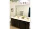 Elegant bathroom with double vanity, dark wood cabinets and modern fixtures at 153 Via Di Mello, Henderson, NV 89011