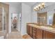 Bathroom featuring double sinks, a walk-in shower, and a soaking tub at 153 Via Di Mello, Henderson, NV 89011