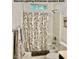 Well-lit bathroom featuring a tub with shower and decorative curtain at 153 Via Di Mello, Henderson, NV 89011
