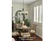 Elegant dining area featuring a stylish chandelier and window with custom shutters providing ample natural light at 153 Via Di Mello, Henderson, NV 89011