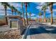 View of the Villa Palermo entrance with stone sign and tall palm trees at 153 Via Di Mello, Henderson, NV 89011