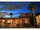 A beautiful two-story home showcases desert landscaping and a welcoming entry with a dramatic, cloudy sky at 153 Via Di Mello, Henderson, NV 89011
