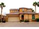 Stylish home featuring mature palm trees, desert landscaping, and a brick driveway with two-car garage at 153 Via Di Mello, Henderson, NV 89011