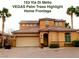 Inviting two-story home featuring an attached two car garage and lush palm trees enhancing curb appeal at 153 Via Di Mello, Henderson, NV 89011