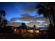 Exterior view of a home at twilight, showcasing desert landscaping with a blue and cloudy sky at 153 Via Di Mello, Henderson, NV 89011