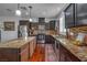 Modern kitchen with stainless steel appliances, granite countertops, and dark wood cabinetry at 153 Via Di Mello, Henderson, NV 89011