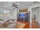 Bright and open living room with hardwood floors, lots of light, and a ceiling fan at 153 Via Di Mello, Henderson, NV 89011
