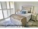 Well-lit main bedroom showcasing custom shutters, stylish decor, and comfortable bedroom furniture and neutral color palette at 153 Via Di Mello, Henderson, NV 89011
