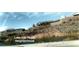 Picturesque Lake Las Vegas neighborhood featuring charming homes, a lush landscape, and lake views at 153 Via Di Mello, Henderson, NV 89011