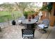 Cozy patio features a wrought iron table with seating for four, plants, and green golf course views at 153 Via Di Mello, Henderson, NV 89011