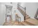 Staircase with carpeted steps, decorative railing, and tiled floors, showing interior details at 153 Via Di Mello, Henderson, NV 89011