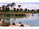 Scenic waterfront view of a lush golf course with palm trees and tranquil waters, offering a serene and picturesque setting at 153 Via Di Mello, Henderson, NV 89011