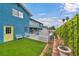 Side yard with artificial turf, mature hedges and view of pool area at 1601 Eaton Dr, Las Vegas, NV 89102
