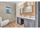 Well-lit bathroom with double sinks, wood-look accent wall, and modern fixtures at 1601 Eaton Dr, Las Vegas, NV 89102