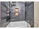 Modern tub/shower combination with sleek gray tile and built-in niche at 1601 Eaton Dr, Las Vegas, NV 89102