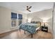 Well-lit bedroom featuring hardwood floors, windows, and a queen bed at 1601 Eaton Dr, Las Vegas, NV 89102