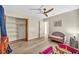 Bright bedroom featuring hardwood floors, a ceiling fan, and cozy furnishings at 1601 Eaton Dr, Las Vegas, NV 89102