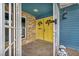 Charming front entrance with double yellow doors, stone accents, and secure gated entry at 1601 Eaton Dr, Las Vegas, NV 89102