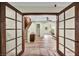 Inviting entryway with glass doors, hardwood floors, and view of the staircase and living area at 1601 Eaton Dr, Las Vegas, NV 89102