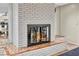 Close-up of brick fireplace with decorative tile and glass screen in a modern living room at 1601 Eaton Dr, Las Vegas, NV 89102