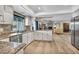 Open kitchen with granite countertops, stainless steel appliances, and view to the living room at 1601 Eaton Dr, Las Vegas, NV 89102