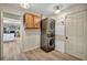 Convenient laundry room featuring stacked washer and dryer and additional storage space at 1601 Eaton Dr, Las Vegas, NV 89102