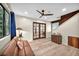 Spacious living room featuring hardwood floors, stylish seating, and a ceiling fan at 1601 Eaton Dr, Las Vegas, NV 89102