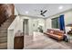 Living room with hardwood floors, modern seating, and stairs to a loft area at 1601 Eaton Dr, Las Vegas, NV 89102